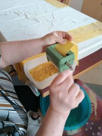 Midsection of woman preparing pasta at home