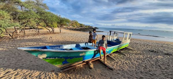 Boats on beach against sky