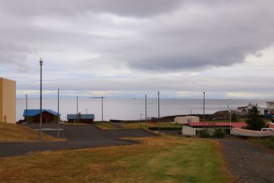 Road by sea against sky in city