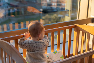 High angle view of cute baby boy sitting on table