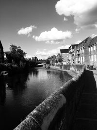 River by houses against sky