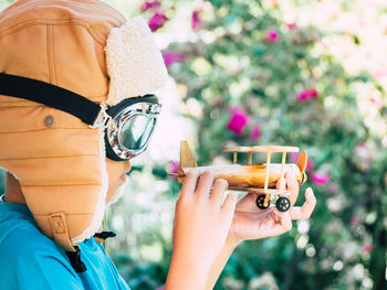 Close-up of boy holding model airplane