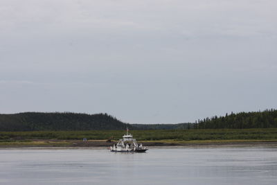 Boat sailing on sea against sky