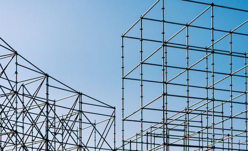 Low angle view of metallic structure against blue sky