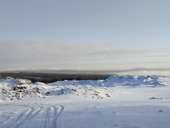 Scenic view of snow covered landscape against sky