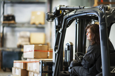 Woman driving forklift truck