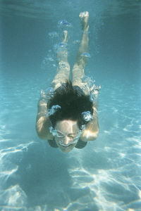 High angle view of woman swimming in sea