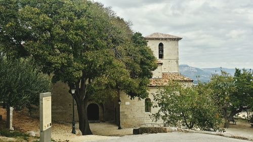 Facade of historic building against cloudy sky