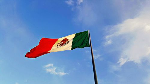 Low angle view of mexican flag against sky