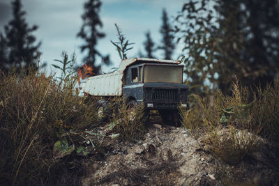 Abandoned car on field