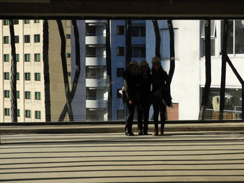 Rear view of people walking on staircase in city