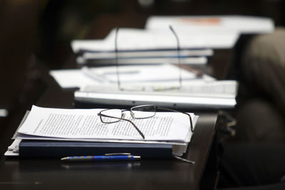 Close-up of paper on book on table