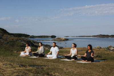 People meditating at sea