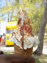 Close-up of hand holding ice cream cone