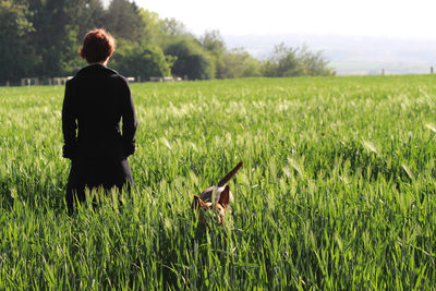 Rear view of boy standing on field