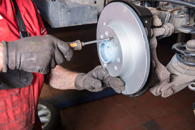 Midsection of manual worker working at workshop