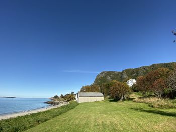 Scenic view of sea against clear blue sky