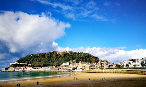 Scenic view of beach against blue sky