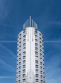 Low angle view of modern building against blue sky