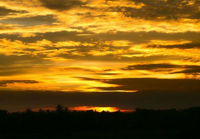 Scenic view of dramatic sky at sunset