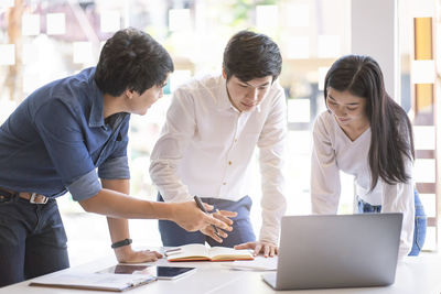 Group of people looking at smart phone