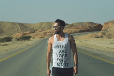 Man standing on road against clear sky