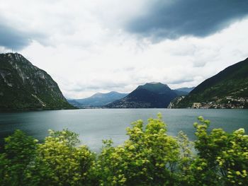 Scenic view of lake and mountains against sky