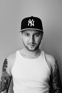 Portrait of man standing against white background