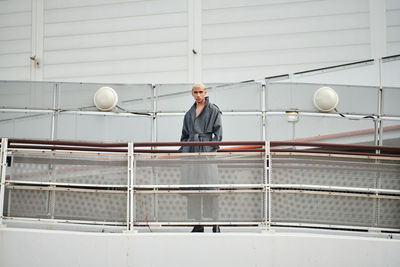 Full length portrait of man standing on boat deck