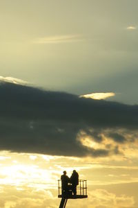 Low angle view of silhouette trees against sky at sunset