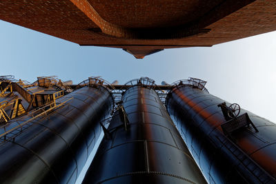 Low angle view of factory against sky