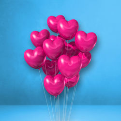 Close-up of pink balloons against blue background