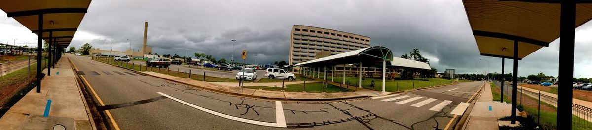 Cars on road in city against sky