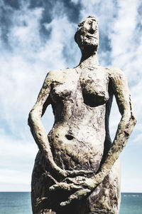 Close-up of statue against sea and sky