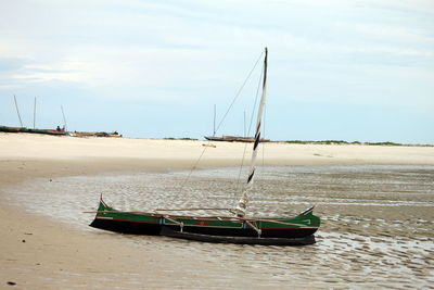 Boats in sea against sky