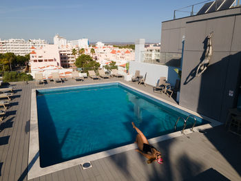 High angle view of swimming pool against buildings in city