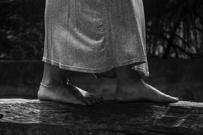 Low section of woman standing on wood