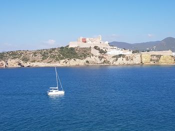 Sailboat sailing on sea against sky