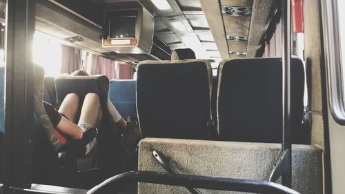 Low section of man sitting in train