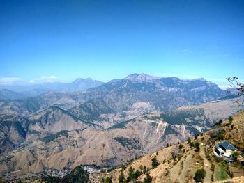 Scenic view of mountains against blue sky