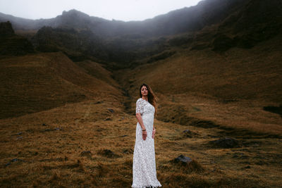 Portrait of woman standing on mountain