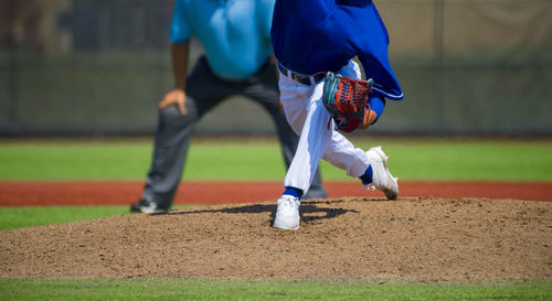 Low section view of baseball players standing on playing field