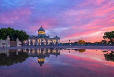 Reflection of building in lake at sunset