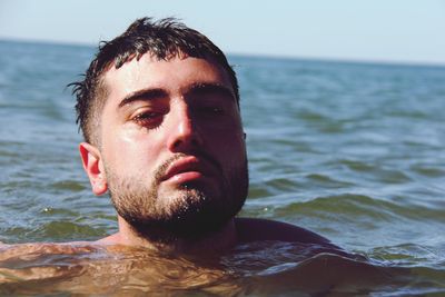 Close-up portrait of man swimming in sea during summer