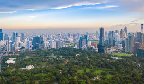 Aerial view of buildings in city against sky