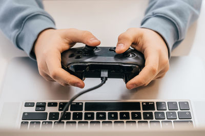 Midsection of person using laptop on table