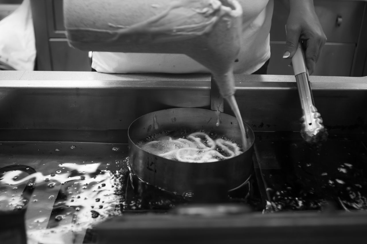 CLOSE-UP OF PERSON PREPARING FOOD