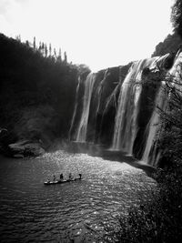 Scenic view of waterfall against sky