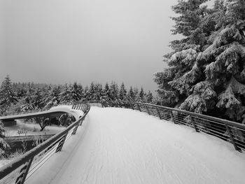 Snow covered road against sky