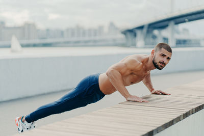 Full length of young man climbing outdoors